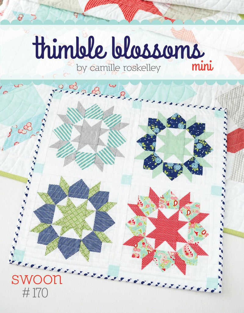 Photo of mini quilt, with four starburst/flower designs